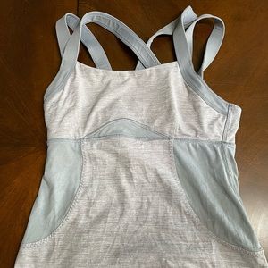 Grey Lululemon tank top; straps cross in back. Floral mesh design on back